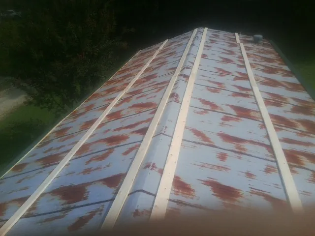 Rusted metal roof panels with new wood purlins before replacement — Storm Damage Roof Repair in Roebling by Roofing Brothers