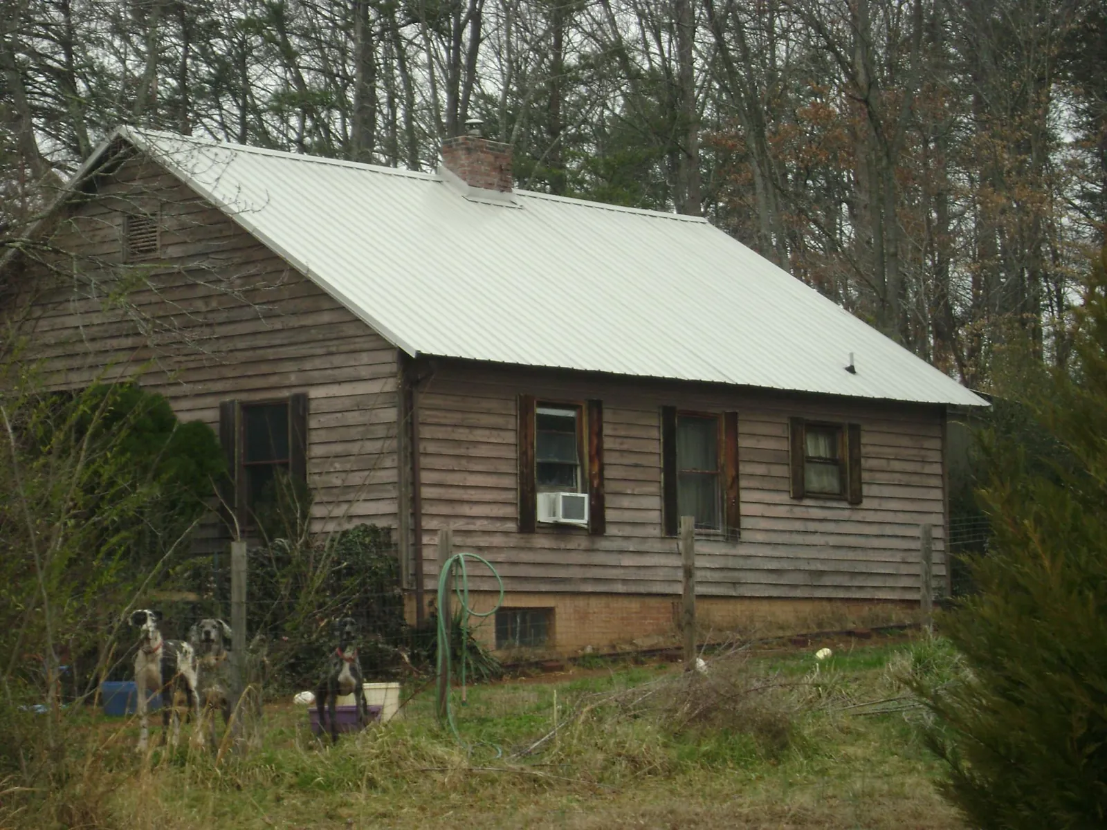 White metal roof on an old wood sided farmhouse, from a Metal Roof Installation job in Roebling